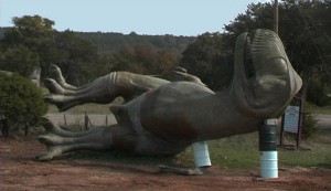photo of a dinosaur statue on its side