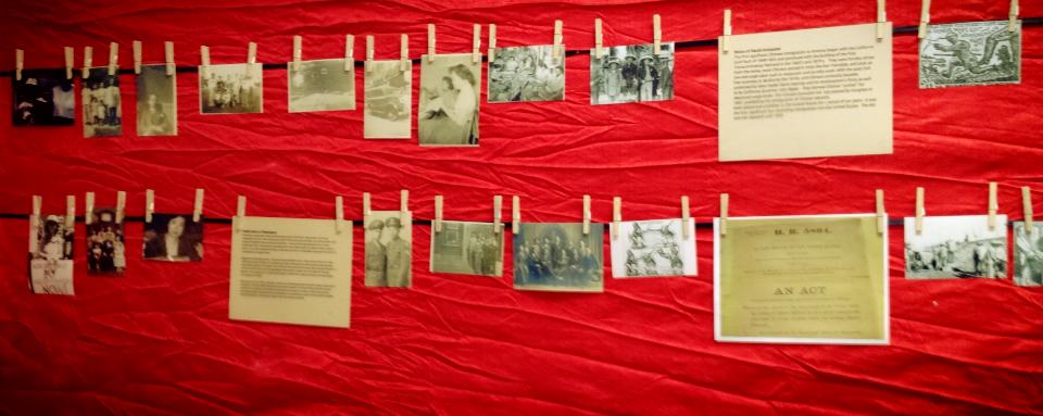 A photograph of two lines with photos hanging from them