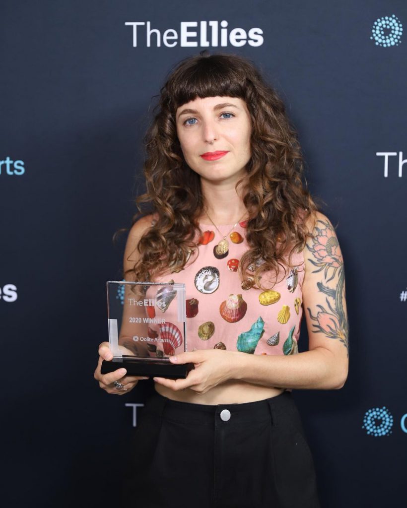 Sasha Wortzel holds award