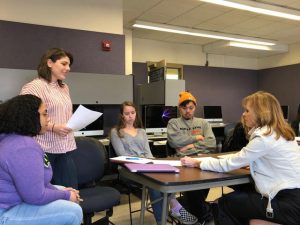 Linda Vester doing a peer review with a standing student along with Sissel McCarthy's other students.