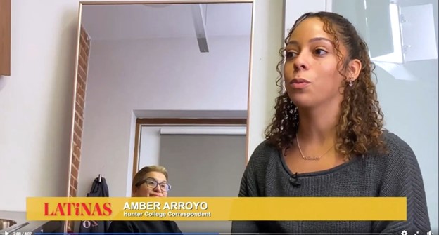Still from Amber Arroyo's segment. The image features the student talking about embracing her hair as a woman looks on from the back.