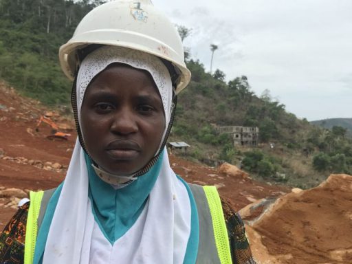 Musu Jabbie, survivor of a deadly landslide in which she lost her husband and sister, shown doing remedial work at the same site, Sugarloaf Mountain in Sierra Leone, during the commemorative tree-planting ceremony. She was photographed by Pulitzer fellow Kadia Goba during her summer 2018 reporting trip there.