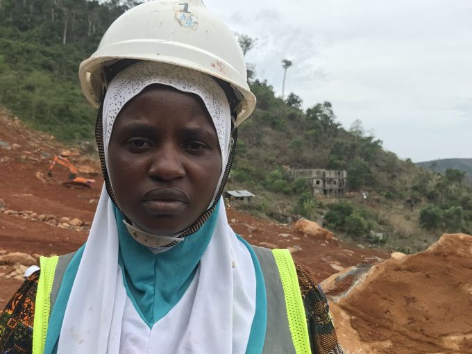 Musu Jabbie, survivor of a deadly landslide in which she lost her husband and sister, shown doing remedial work at the same site, Sugarloaf Mountain in Sierra Leone, during the commemorative tree-planting ceremony. She was photographed by Pulitzer fellow Kadia Goba during her summer 2018 reporting trip there.
