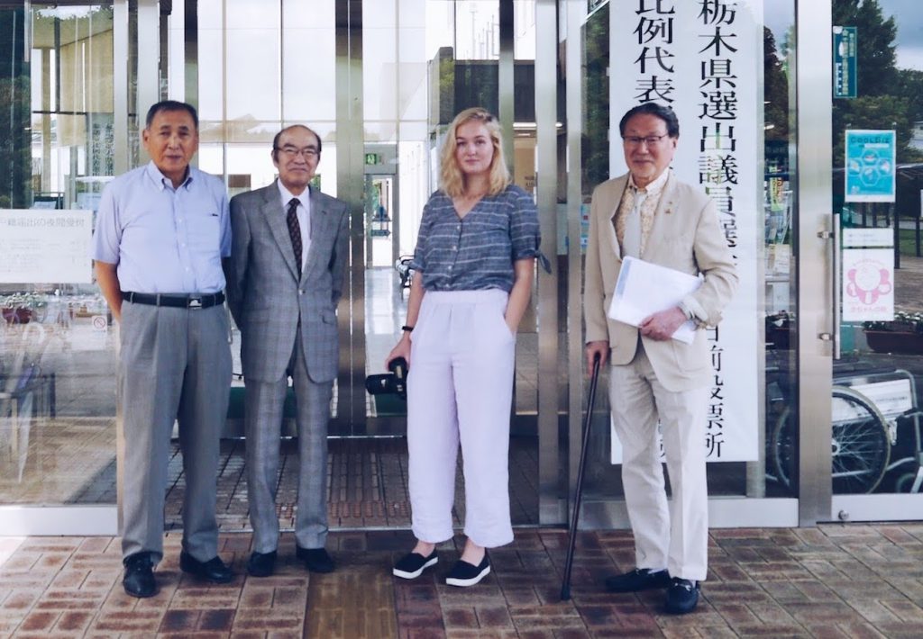 Pulitzer Center fellowship winner Audrey Henson on her reporting trip in Japan last summer, with officials from a dementia support group.