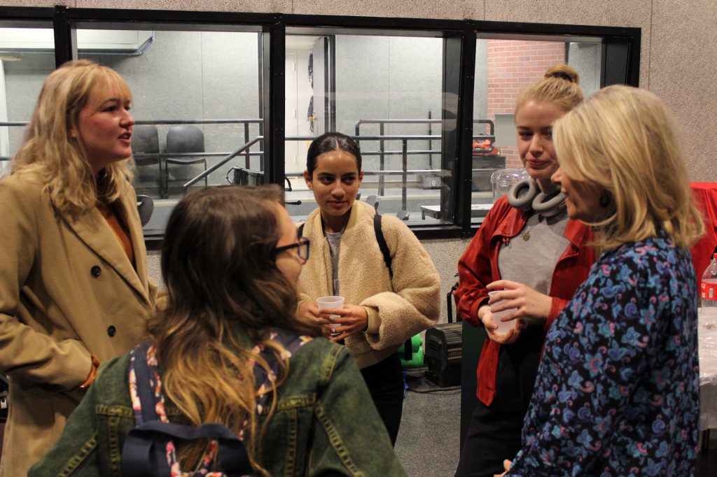 At the Oct. 23 journalism pizza party, Journalism Program Director Sissel McCarthy (far right) chats with students (clockwise from front) Gabriella Vetrano, Audrey Henson, Rebecca West and Emilia Nygren. PHOTO: Kalli Siringas