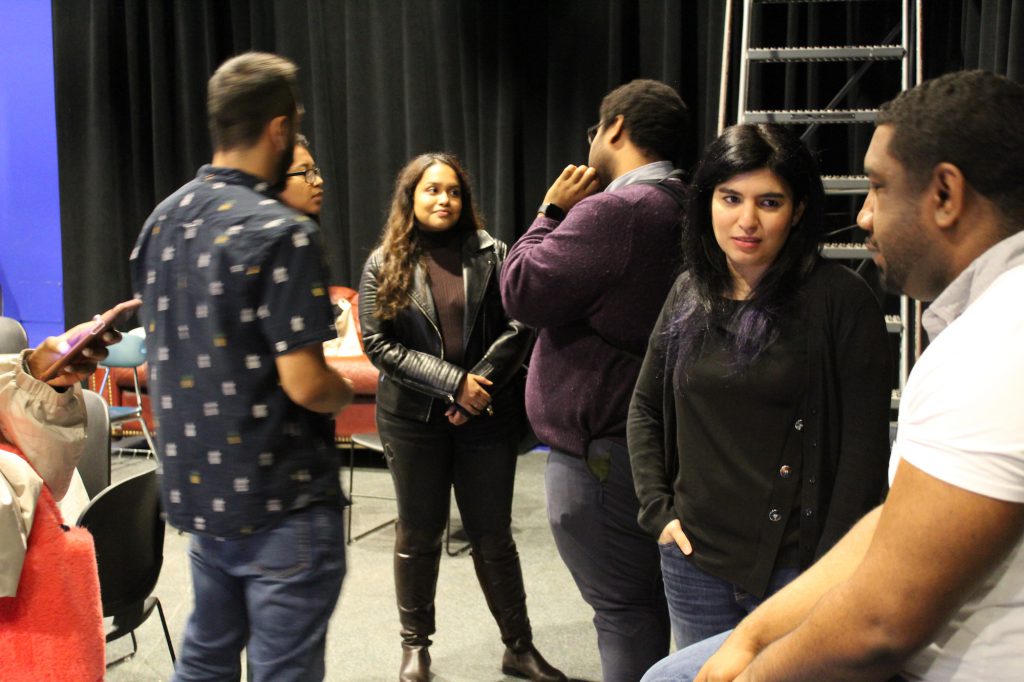 New adjunct faculty members (from right) Khristopher Brooks, Bianca Silva and Emmanuel Felton, speak with students Afia Eama, Rebecca Lent and Richard Mendez.