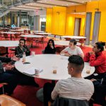 Ken Nelson of the New York Times (at left) speaks with students of the journalism program's Neighborhood News class.
