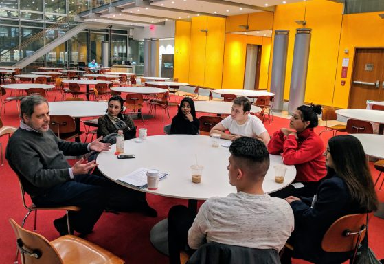Ken Nelson of the New York Times (at left) speaks with students of the journalism program's Neighborhood News class.