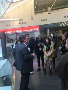 Bloomberg financial news journalist Rob Urban (left) tells Hunter students about the company in its HQ on Nov. 9.