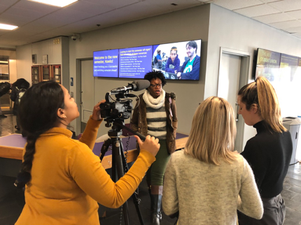 Student journalists capture the action at Student Press Day outside Hunter West.