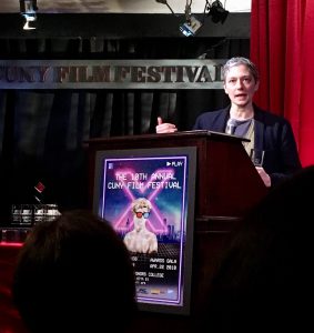 Farinella speaks at podium CUNY award